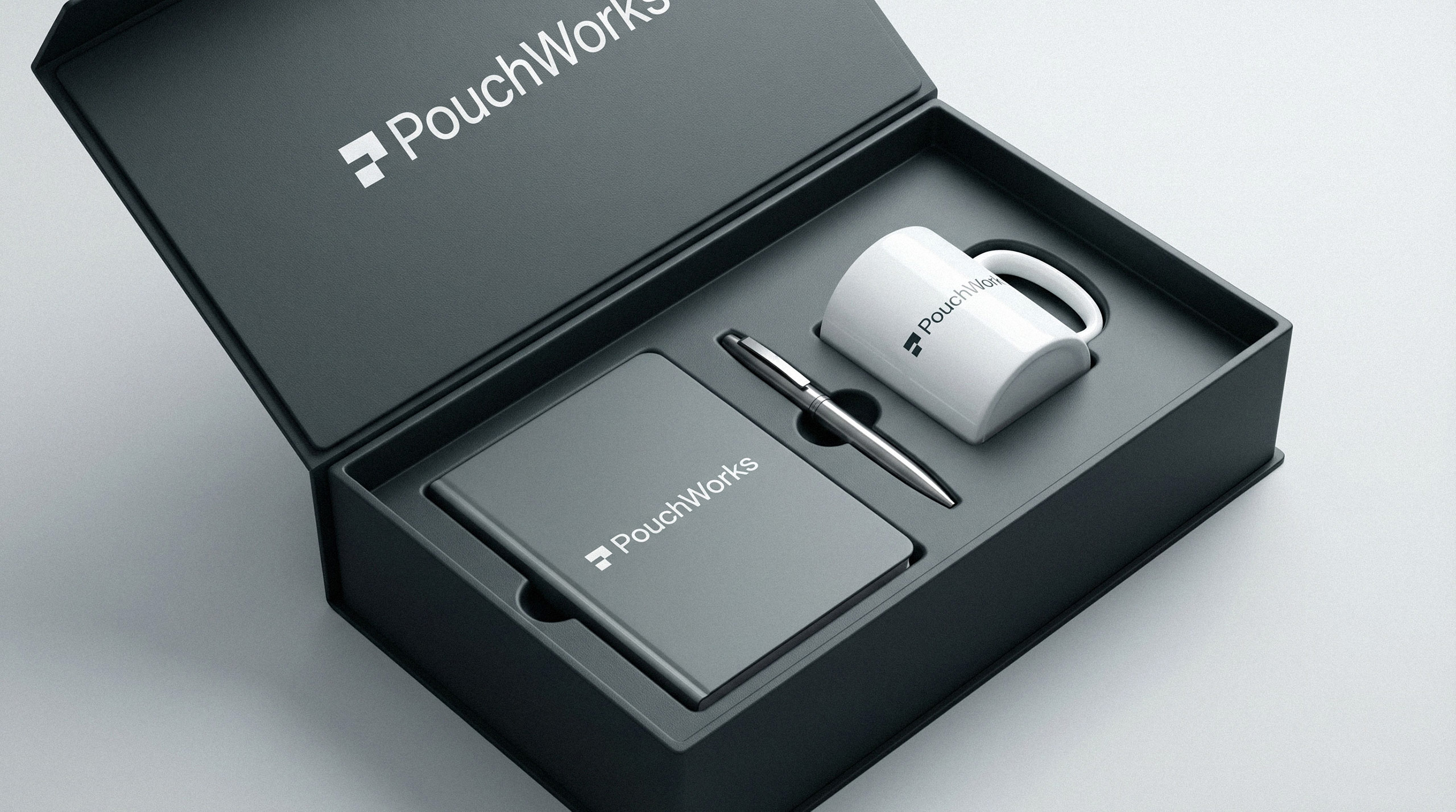 Branded corporate welcome kit mockup including a black box, mug, pen, and notebook by Brandforma Studio
