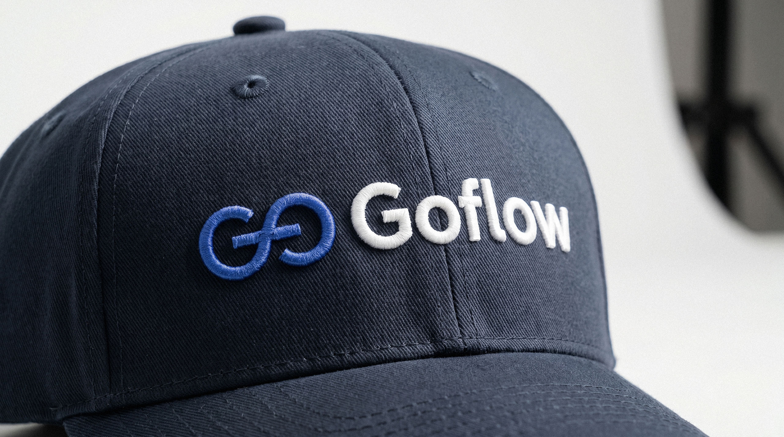Dark blue baseball cap with a 3D embroidered Goflow logo